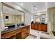 Spa-like bathroom with double sinks, a large mirror, and stylish cabinetry at 145 E Harmon Ave # 2120, Las Vegas, NV 89109