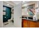 Modern bathroom with dark wood cabinets and a large mirror at 145 E Harmon Ave # 2120, Las Vegas, NV 89109