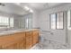 Double vanity bathroom with granite countertop and marble-look floor at 1911 Hobson Dr, Henderson, NV 89074