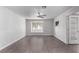 Spacious living room with grey wood-look flooring and ceiling fan at 1911 Hobson Dr, Henderson, NV 89074