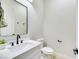 Modern powder room with white vanity, black matte fixtures, and a white quartz countertop at 1928 Oliver Springs St, Henderson, NV 89052