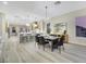 Open concept dining area with a long wooden table and black chairs, adjacent to the kitchen at 1928 Oliver Springs St, Henderson, NV 89052