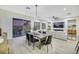 Bright dining area with a large wooden table and modern chairs, overlooking the backyard at 1928 Oliver Springs St, Henderson, NV 89052