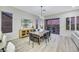 Spacious dining area with a wooden table, modern chairs and views of the backyard at 1928 Oliver Springs St, Henderson, NV 89052