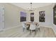 Bright dining room with hardwood floors, a round wooden table, and a modern chandelier at 1928 Oliver Springs St, Henderson, NV 89052