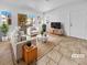 Virtually staged living room with contemporary furniture and tile floors at 1955 Cutlass Dr # 1955, Henderson, NV 89014