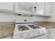 White stove with four burners and built-in microwave at 1955 Cutlass Dr # 1955, Henderson, NV 89014