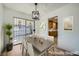 Virtually staged dining room with wood floors and kitchen access at 200 Rancho Vista Dr, Las Vegas, NV 89106