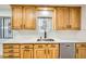 Kitchen features wood cabinets, white quartz countertops and a stainless steel sink at 200 Rancho Vista Dr, Las Vegas, NV 89106