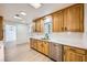 Kitchen features wood cabinets, quartz countertops, and stainless steel appliances at 200 Rancho Vista Dr, Las Vegas, NV 89106