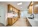 Bright kitchen with light wood cabinets, stainless steel appliances, and quartz countertops at 200 Rancho Vista Dr, Las Vegas, NV 89106