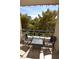 Relaxing balcony with patio furniture and treetop views at 230 E Flamingo Rd # 334, Las Vegas, NV 89169