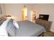 King bed, dresser, TV, and view into bathroom and living area at 230 E Flamingo Rd # 334, Las Vegas, NV 89169