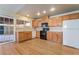 Bright kitchen with light wood cabinets, hardwood floors, and modern appliances at 2422 Paradise Village Way, Las Vegas, NV 89104