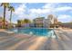 Inviting community pool with palm trees and a clubhouse at 2422 Paradise Village Way, Las Vegas, NV 89104