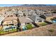 Aerial view of homes with pools, lush landscaping, and mountain backdrop at 2469 Cingoli St, Henderson, NV 89044