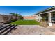 Artificial turf backyard with a pool and patio at 2469 Cingoli St, Henderson, NV 89044