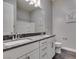 Modern bathroom with double vanity, granite countertop, and gray floors at 2469 Cingoli St, Henderson, NV 89044