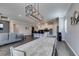 Open dining area with modern light fixture and concrete table at 2469 Cingoli St, Henderson, NV 89044