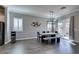 Modern dining room with concrete table, bench seating, and sliding glass doors at 2469 Cingoli St, Henderson, NV 89044