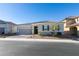 Single-story home with gray exterior, two-car garage, and landscaping at 2469 Cingoli St, Henderson, NV 89044