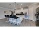 Modern kitchen with granite countertops, white cabinets, and breakfast bar at 2469 Cingoli St, Henderson, NV 89044