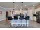 Modern kitchen with granite countertops, white cabinets, and breakfast bar at 2469 Cingoli St, Henderson, NV 89044