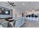 Open living room with a view into the kitchen and gray sofas at 2469 Cingoli St, Henderson, NV 89044