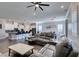 Spacious living room with gray reclining sofas and wood-look floors at 2469 Cingoli St, Henderson, NV 89044