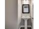 Elegant powder room featuring pedestal sink and framed mirror at 2469 Cingoli St, Henderson, NV 89044