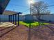 Landscaped backyard with artificial turf, storage shed, and covered patio at 2820 Richfield Blvd, Las Vegas, NV 89102