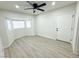 Well-lit bedroom with gray flooring, ceiling fan, and an exterior door at 2820 Richfield Blvd, Las Vegas, NV 89102