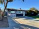 Ranch-style home with gray exterior, large driveway, and landscaping at 2820 Richfield Blvd, Las Vegas, NV 89102