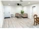 Bright living room with gray vinyl flooring and a view to the dining area at 2820 Richfield Blvd, Las Vegas, NV 89102