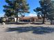 Single story home with landscaped yard and a fire pit at 2891 Oakleaf Ave, Pahrump, NV 89048