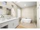 Modern bathroom with double vanity, soaking tub, and glass shower at 3016 Darby Falls Dr, Las Vegas, NV 89134