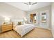 Bright bedroom with large window and wood-look floors at 3016 Darby Falls Dr, Las Vegas, NV 89134