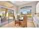 Kitchen breakfast nook with glass table and wicker chairs at 3016 Darby Falls Dr, Las Vegas, NV 89134