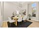 Modern dining room with light wood table and statement chandelier at 3016 Darby Falls Dr, Las Vegas, NV 89134