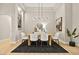 Modern dining room features a light wood table and statement chandelier at 3016 Darby Falls Dr, Las Vegas, NV 89134