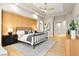 Main bedroom with wood-paneled wall, metal bed frame, and wood flooring at 3016 Darby Falls Dr, Las Vegas, NV 89134