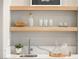 Modern wet bar with floating shelves and quartz countertop at 3016 Darby Falls Dr, Las Vegas, NV 89134