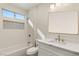 Bathroom with white vanity, marble countertop, and a tiled shower/tub combo at 3110 Scotts Valley Dr, Henderson, NV 89052