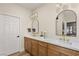 Spa-like bathroom with double sinks, marble counters, and updated light fixtures at 3110 Scotts Valley Dr, Henderson, NV 89052