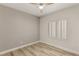 Bright bedroom with wood-look floors, neutral walls, and plantation shutters at 3110 Scotts Valley Dr, Henderson, NV 89052