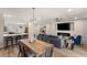 Open concept dining room with kitchen views and wood dining table at 3110 Scotts Valley Dr, Henderson, NV 89052