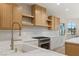 Modern kitchen with light wood cabinets and marble countertops at 3110 Scotts Valley Dr, Henderson, NV 89052