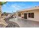 Covered patio with ceiling fan, adjacent to desert landscaping at 3110 Scotts Valley Dr, Henderson, NV 89052