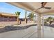 Covered patio with ceiling fan, desert landscaping, and rock garden at 3110 Scotts Valley Dr, Henderson, NV 89052