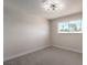 Simple bedroom with gray carpet and large window at 3314 El Camino Real, Las Vegas, NV 89121